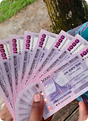 Bangladeshi taka banknotes held in a hand